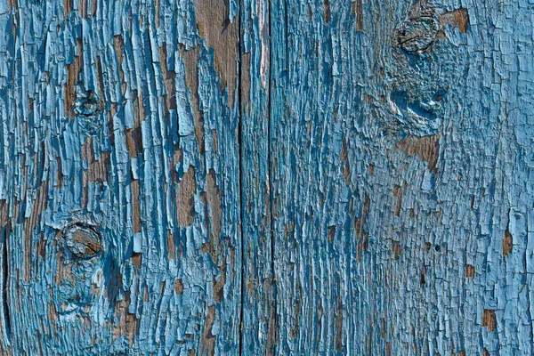 Pintura azul sobre una vieja tabla vertical de madera. Primer plano. el fondo. spase de copia — Foto de Stock