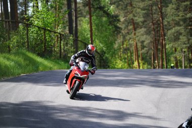 10-05-2020 Ropazi, Letonya motorsikletçisi boş asfalt yolda bisiklet sürüyor. spor bisikleti.