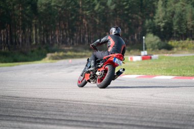 10-09-2020 Ropazi, Latvia Motorcyclist at sport bike rides by empty asphalt road. sport bike. Motorcyclist training.