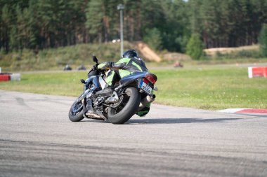 10-09-2020 Ropazi, Latvia Motorcyclist at sport bike rides by empty asphalt road. sport bike. Motorcyclist training.