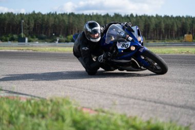 10-09-2020 Ropazi, Latvia Motorcyclist at sport bike rides by empty asphalt road. sport bike. Motorcyclist training.