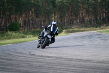 10-09-2020 Ropazi, Latvia Motorcyclist at sport bike rides by empty asphalt road. sport bike. Motorcyclist training.