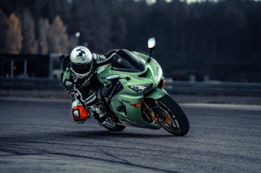 10-09-2020 Ropazi, Latvia Motorcyclist at sport bike rides by empty asphalt road. sport bike.
