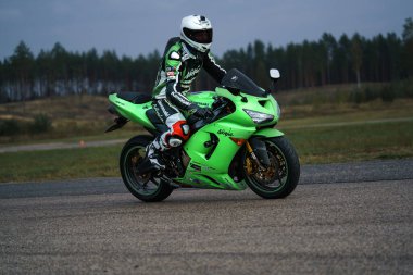 10-09-2020 Ropazi, Latvia Motorcyclist at sport bike rides by empty asphalt road. sport bike.