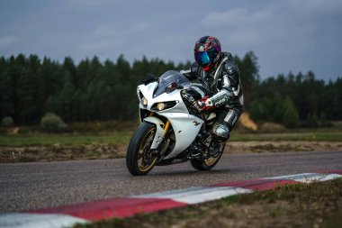 10-09-2020 Ropazi, Latvia Motorcyclist at sport bike rides by empty asphalt road. sport bike.