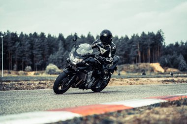 10-09-2020 Ropazi, Latvia Motorcyclist at sport bike rides by empty asphalt road. sport bike.