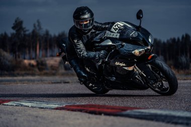 10-09-2020 Ropazi, Latvia Motorcyclist at sport bike rides by empty asphalt road. sport bike.