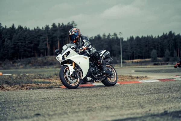 10-09-2020 Ropazi, Latvia Motorcyclist at sport bike rides by empty asphalt road. sport bike.