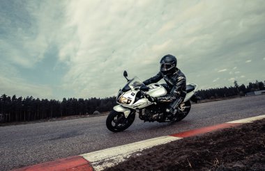 10-09-2020 Ropazi, Latvia Motorcyclist at sport bike rides by empty asphalt road. sport bike.
