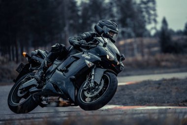 10-09-2020 Ropazi, Latvia Motorcyclist at sport bike rides by empty asphalt road. sport bike.