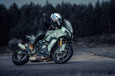 10-09-2020 Ropazi, Latvia Motorcyclist at sport bike rides by empty asphalt road. sport bike.