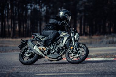 10-09-2020 Ropazi, Latvia Motorcyclist at sport bike rides by empty asphalt road. sport bike.