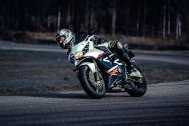 10-09-2020 Ropazi, Latvia Motorcyclist at sport bike rides by empty asphalt road. sport bike.