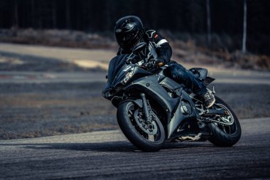 10-09-2020 Ropazi, Latvia Motorcyclist at sport bike rides by empty asphalt road. sport bike.