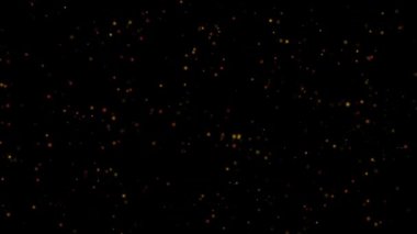 Siyah arkaplanda farklı renklerde hareket eden parlak parçacıklar kümesi. 4k çözünürlüğü.