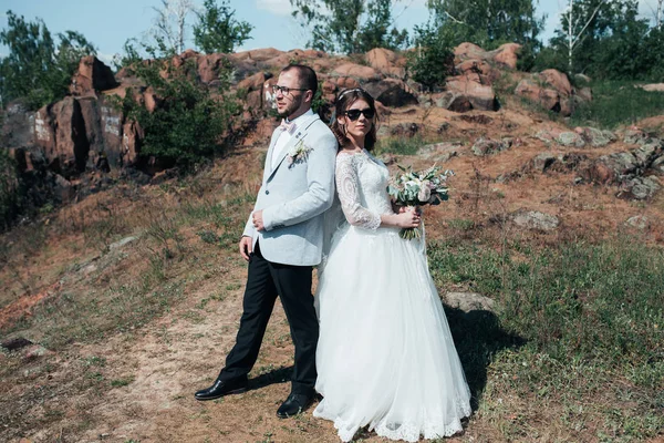 Wedding photography fashionable bride and groom in sunglasses on