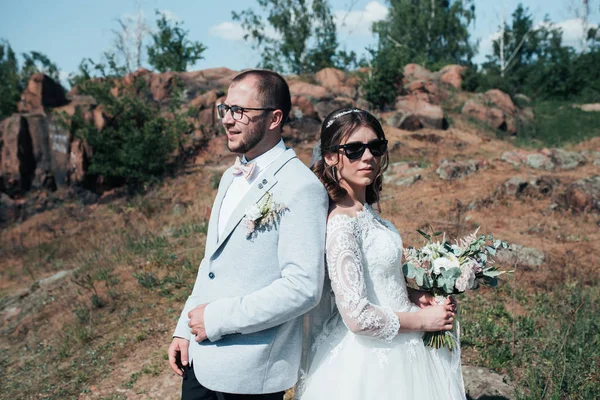 Wedding photography fashionable bride and groom in sunglasses on
