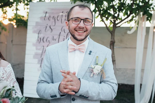 Wedding photo of emotions of a bearded groom with glasses in a g — Stock Photo, Image