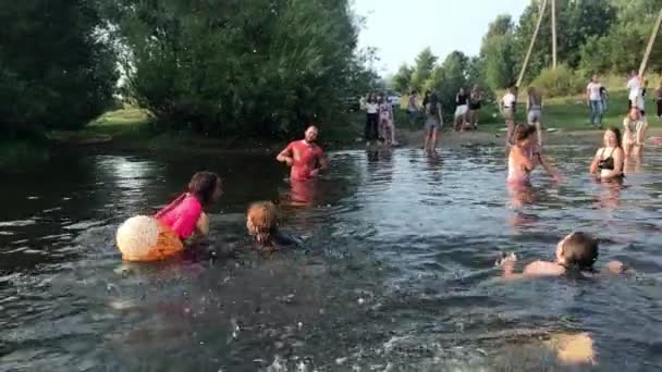 KOROSTEN - AUG, 12, 2019: youth teenage christian camp and active water games. swimming in the river. cardboard ship distillation — Stock Video