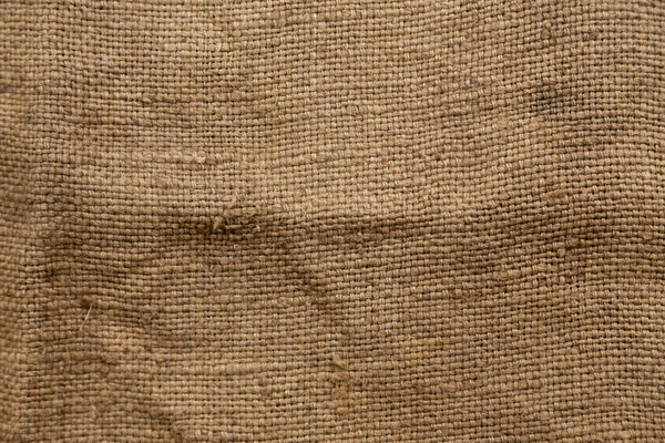 Dark brown background from a textile material with wicker patter