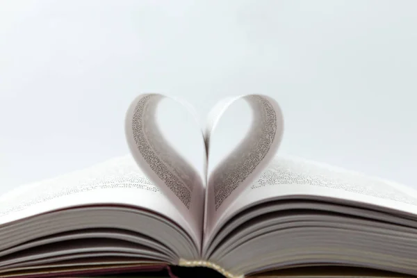 Opened book with heart page. Close-Up Of Heart Shape Made With Papers On Book