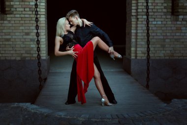 Young dancers perform Argentine tango. Dance of passion in the evening on a date a pair of lovers. clipart
