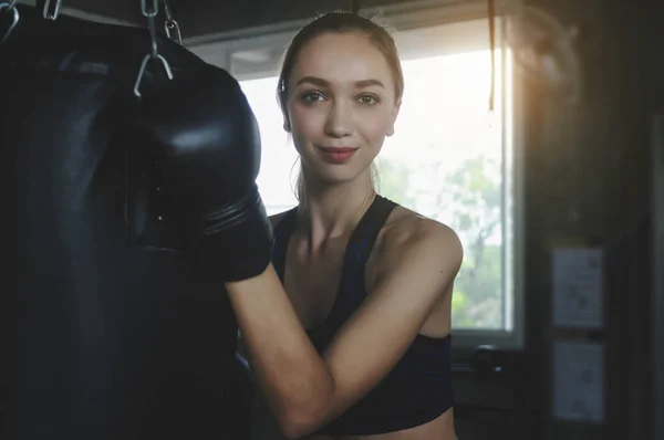 Beautiful Woman with the Black Boxing Gloves. Attractive Female Boxer Training.