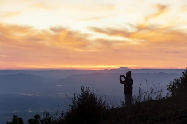 Silhouette women traveller standing to see the highland mountains in northern region of Thailand. - Image