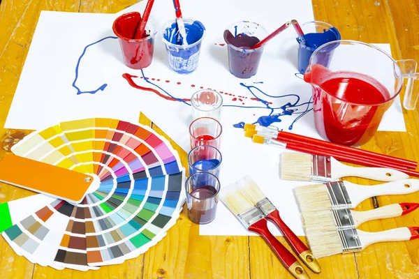 Painter and decorator work table with house project. — Stock Photo, Image