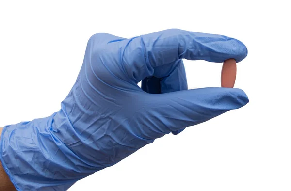 医者は青い手袋で薬を持っている 孤立した背景に手にカプセル ウイルスの治療 — ストック写真