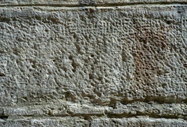 Arkadaki taşlardan eski duvarın dokusu.