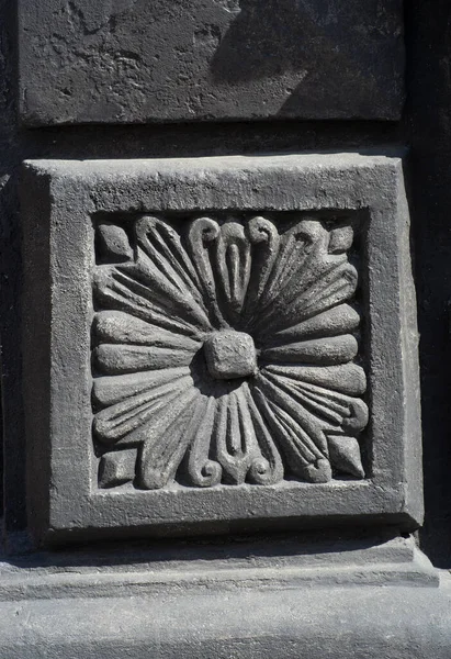 the decorative ornament on the stone of the old building