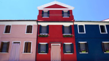 Fantastik pembe, kırmızı veya mavi evler güzel çiçekler, Burano Adası ile dekore edilmiştir.