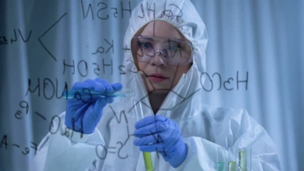 Female chemist mixing liquids, researches in cosmetology, formula on foreground — Stock Video