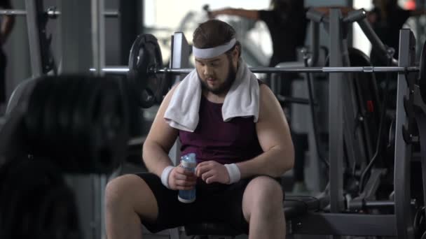 トレーニングの重量トレーニング、使い果たした後水を飲んでのどが渇いて幸せな男 — ストック動画