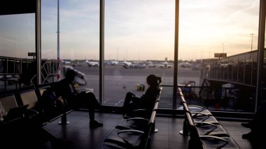 Uçak için bekleyen kalkış lounge, oturan erkek ve kadın yolcu seyahat