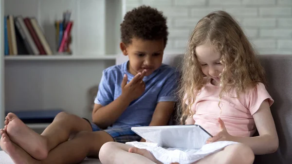 Due Bambini Multirazziali Seduti Accogliente Divano Guardando Cartoni Animati Tablet — Foto Stock