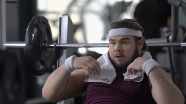 Funny fat man in gym pretending to have strong muscles, attracting  attention — Stock Video © motortion #197905518