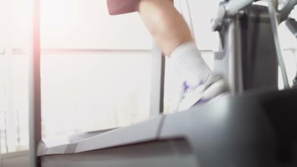 Sportlerbeine laufen auf Laufband im Fitnessstudio, zielorientiert, Ausdauer — Stockvideo