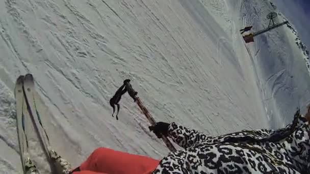 Person skiing downhill with camera on stick taking video, extreme recreation — Stock Video