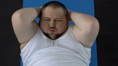 Dublör sit-up egzersiz yaparak ve katta, fiziksel aktivite eksikliği dinlenme adam