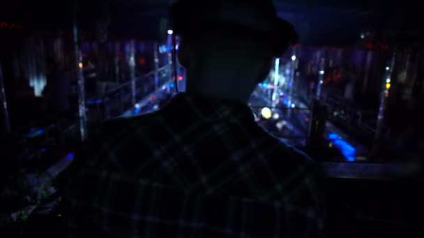 Back view of dj working with sound equipment during performance in night club — Stock Video