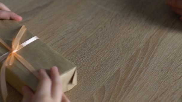 Abuela suavemente acariciando las manos de la nieta que le da su regalo — Vídeos de Stock