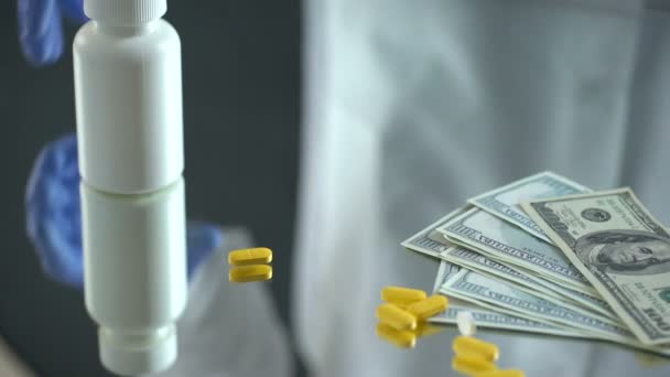 Pharmacist dropping tablets on dollars, pharmaceutical business, expensive drugs — Stock Video