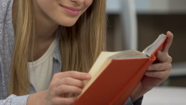 Дівчина читає книгу для самоосвіти, готується до літературного іспиту — стокове відео