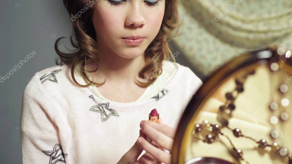 Schoolgirl doing makeup with cosmetics for adults, bright image of young lady