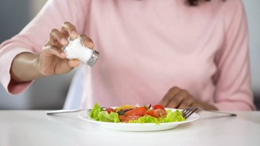 Kadın çok fazla tuz ekleyerek onun yiyecek, sağlıksız beslenme, su kaybı sorunları için