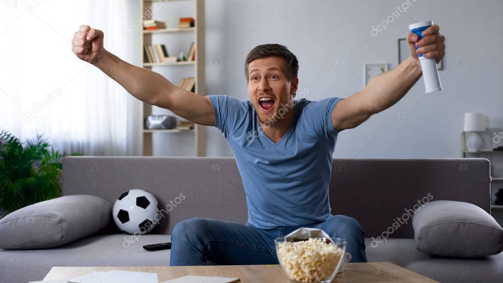 Happy football fan loudly congratulating team on winning tournament, match on tv
