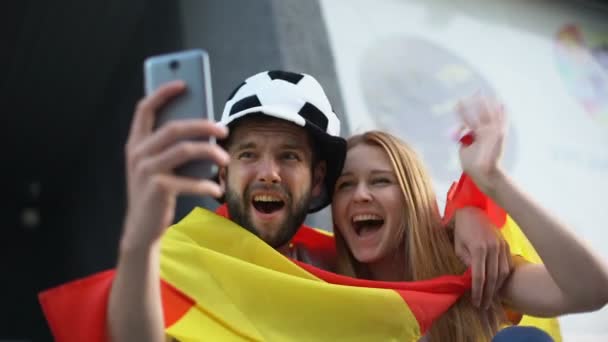 Spanish football supporters calling via video app to friends from stadium — Stock Video