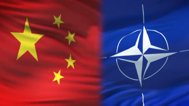 BRUSSELS, BELGIUM - CIRCA JUNE 2018: China and NATO handshake, international friendship relations, flag background — Stock Video